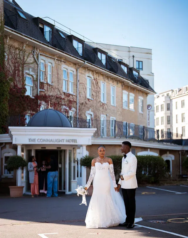 Remi and Daniel in a wider view of the hotel entrance. CameraBoss portfolio: Remi and Daniel’s Bournemouth civil wedding.