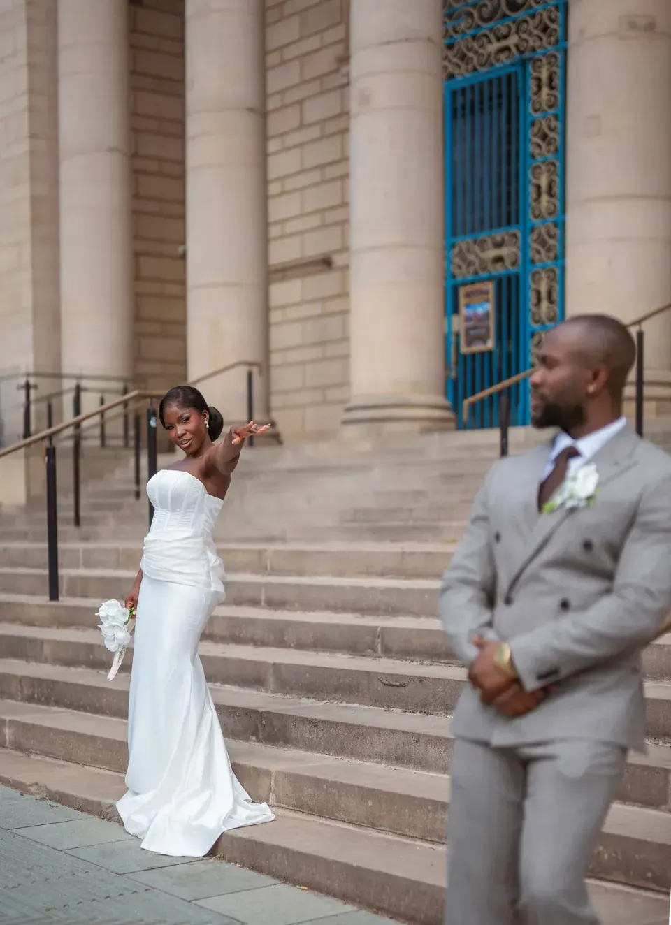 The couple outside a stone building. CameraBoss portfolio: Opeyemi Wedding Portrait.