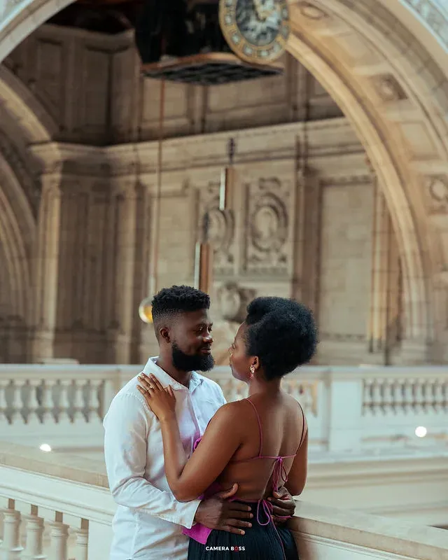 A couple standing together beneath an interior archway. CameraBoss portfolio: Tomilayo Prewedding London.