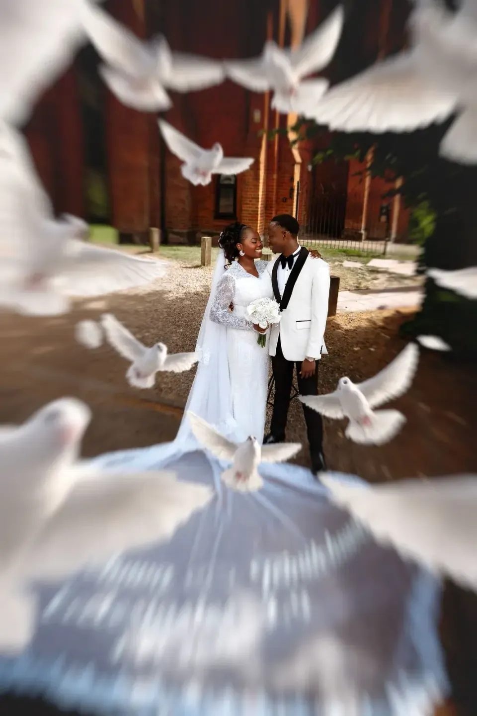 The couple with white doves. CameraBoss portfolio: Temi and Fiyin.