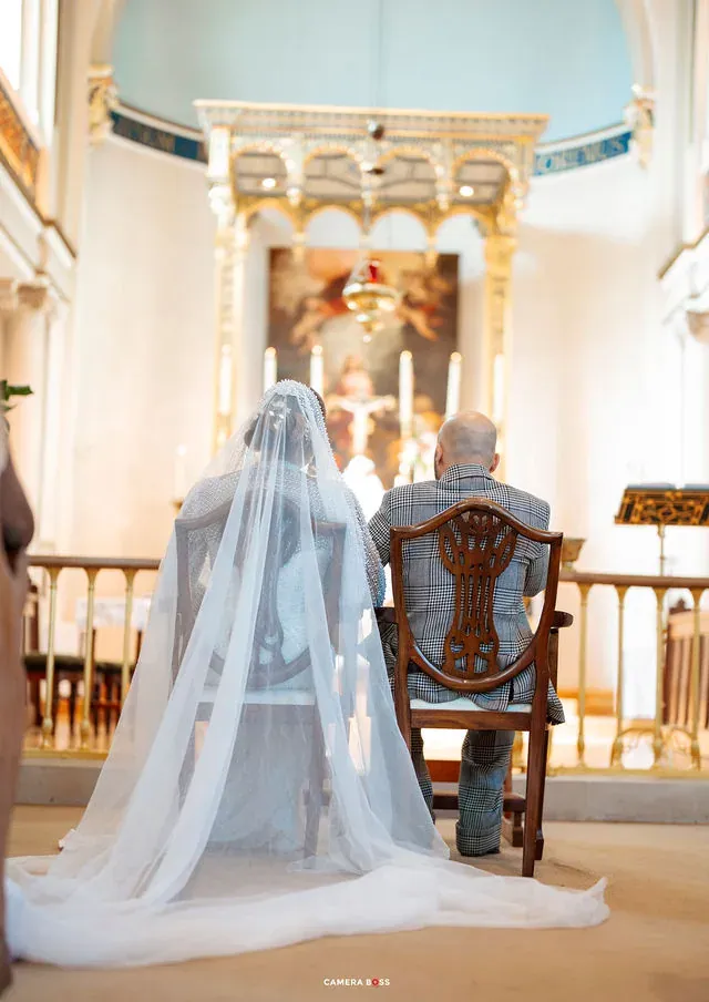 The couple seated together facing the ceremony. CameraBoss portfolio: Cynthia and Oswaldo.