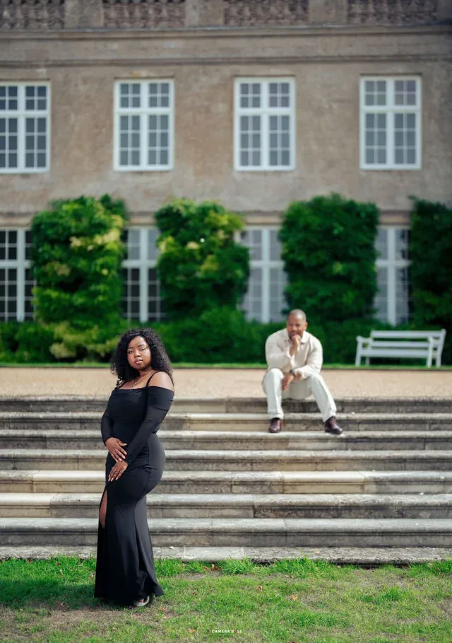 A couple on the steps outside Boughton House. CameraBoss portfolio: Oney Prewedding at Boughton House.