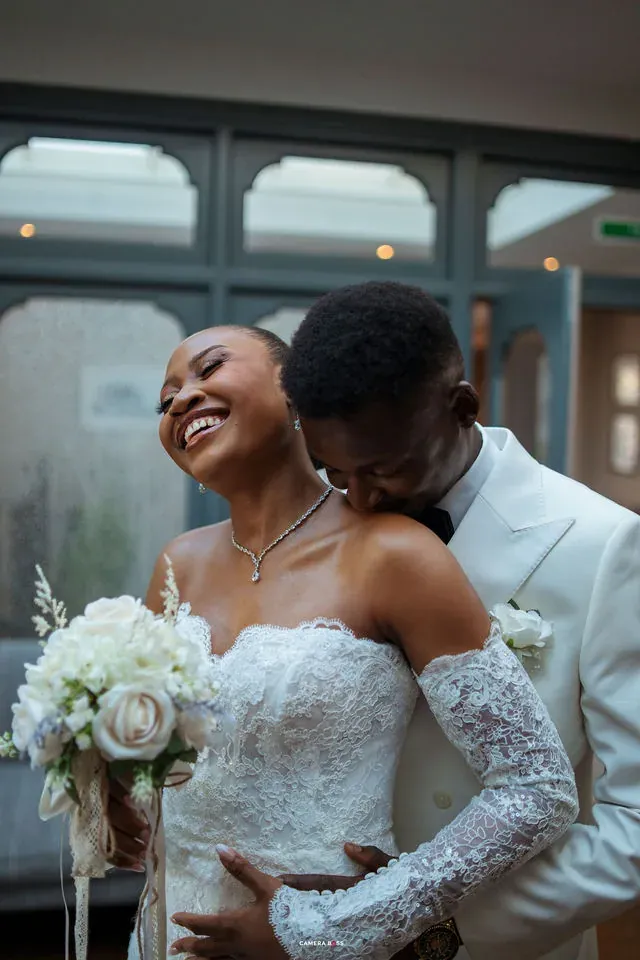 Remi laughing as Daniel leans towards her during their Bournemouth wedding portraits CameraBoss’s Bournemouth wedding portfolio.