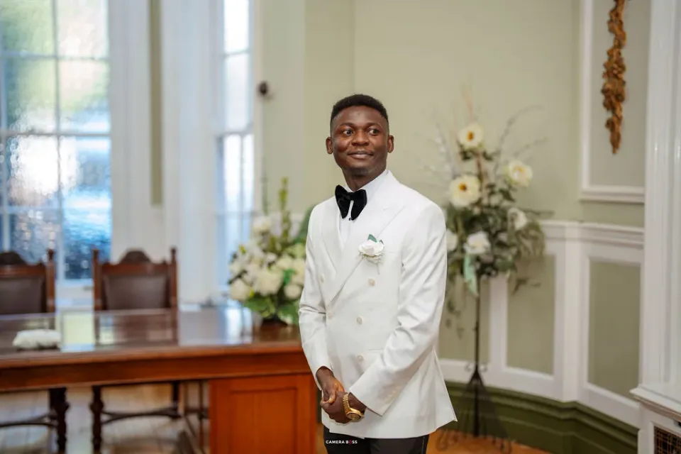 Daniel standing in the bright ceremony room. CameraBoss portfolio: Remi and Daniel’s Bournemouth civil wedding.