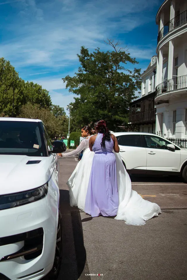 The bride and bridesmaids outside beside a wedding car. CameraBoss portfolio: Cynthia and Oswaldo.