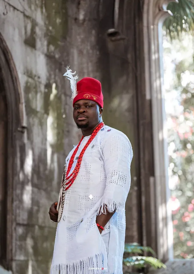 A pre-wedding portrait beside stonework. CameraBoss portfolio: Korede Prewedding.