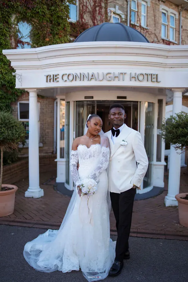 A full-length portrait of Remi and Daniel outside the hotel. CameraBoss portfolio: Remi and Daniel’s Bournemouth civil wedding.