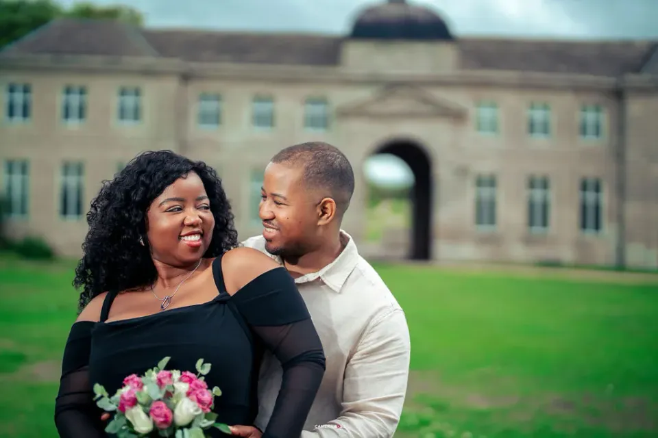 A couple smiling together in a close pre-wedding portrait. CameraBoss portfolio: Oney Prewedding at Boughton House.
