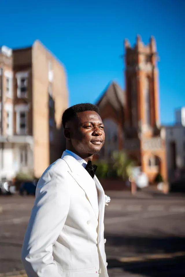 Daniel outdoors in his white dinner jacket. CameraBoss portfolio: Remi and Daniel’s Bournemouth civil wedding.