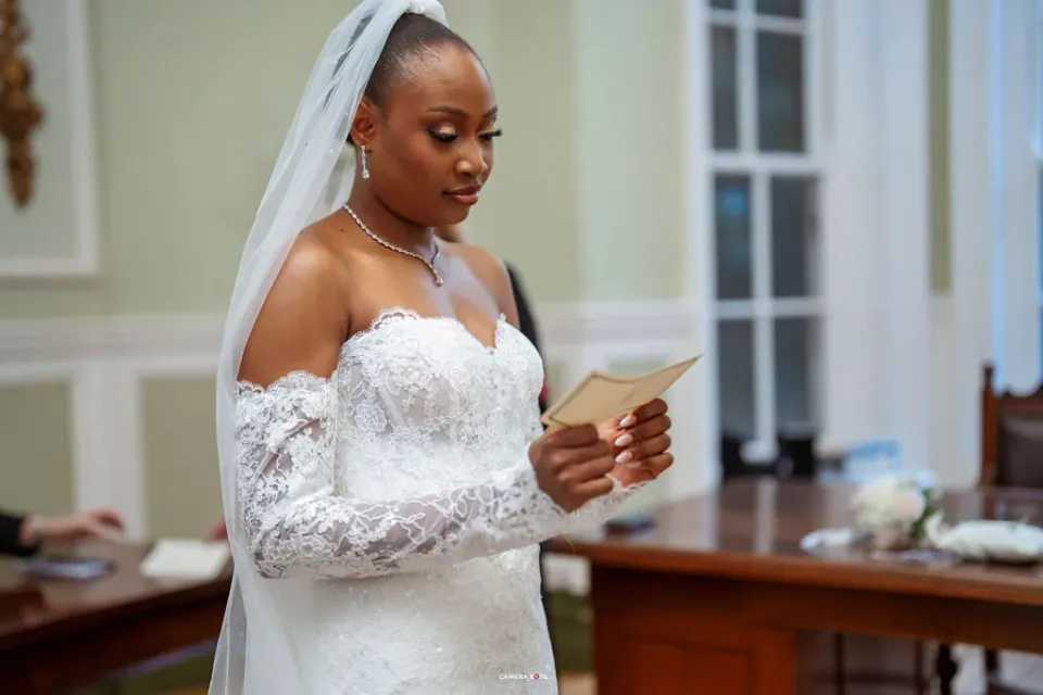 Remi reading from a card during her vows. CameraBoss portfolio: Remi and Daniel’s Bournemouth civil wedding.