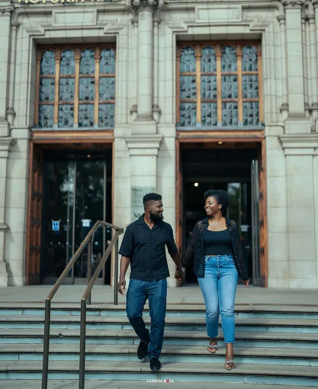 A couple holding hands outside the Victoria and Albert Museum. CameraBoss portfolio: Tomilayo Prewedding London.