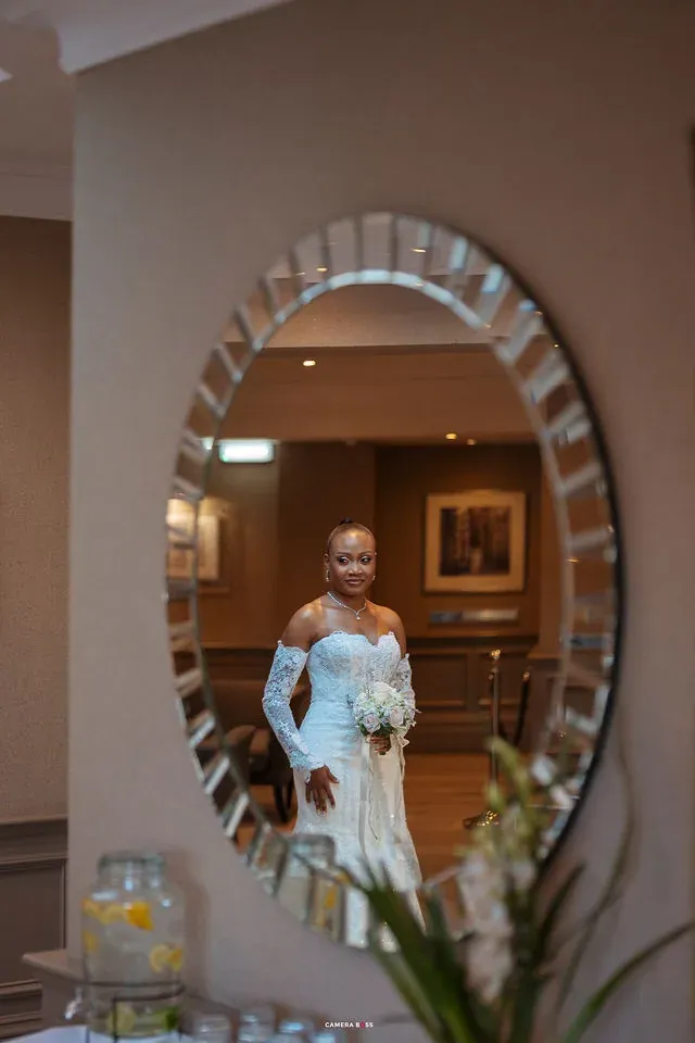 Remi reflected in a mirror before the ceremony. CameraBoss portfolio: Remi and Daniel’s Bournemouth civil wedding.