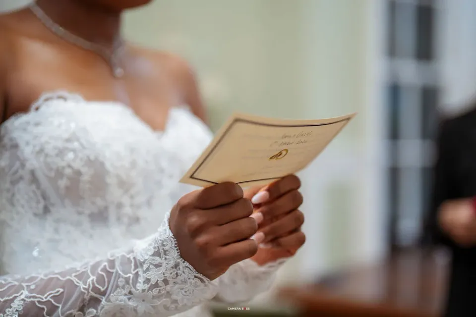Hands holding a card during the wedding ceremony. CameraBoss portfolio: Remi and Daniel’s Bournemouth civil wedding.