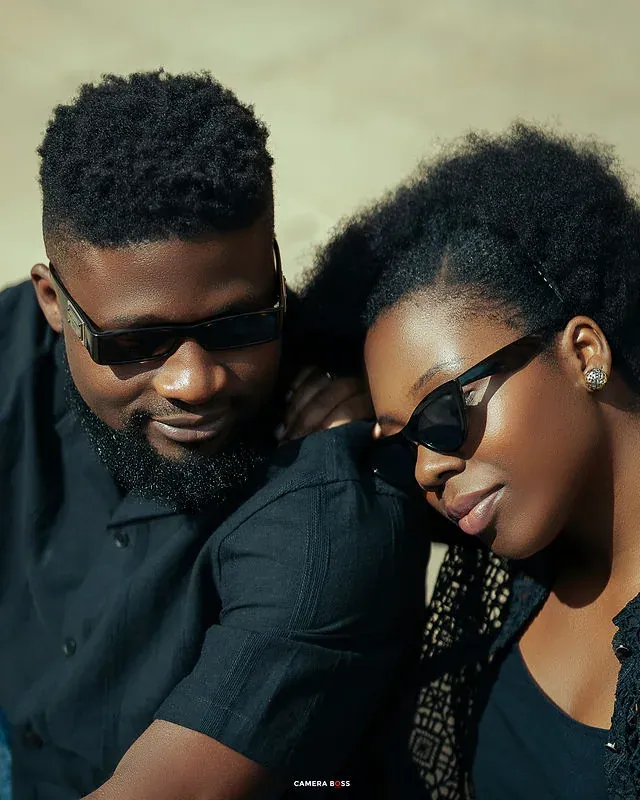 A couple leaning together wearing sunglasses. CameraBoss portfolio: Tomilayo Prewedding London.