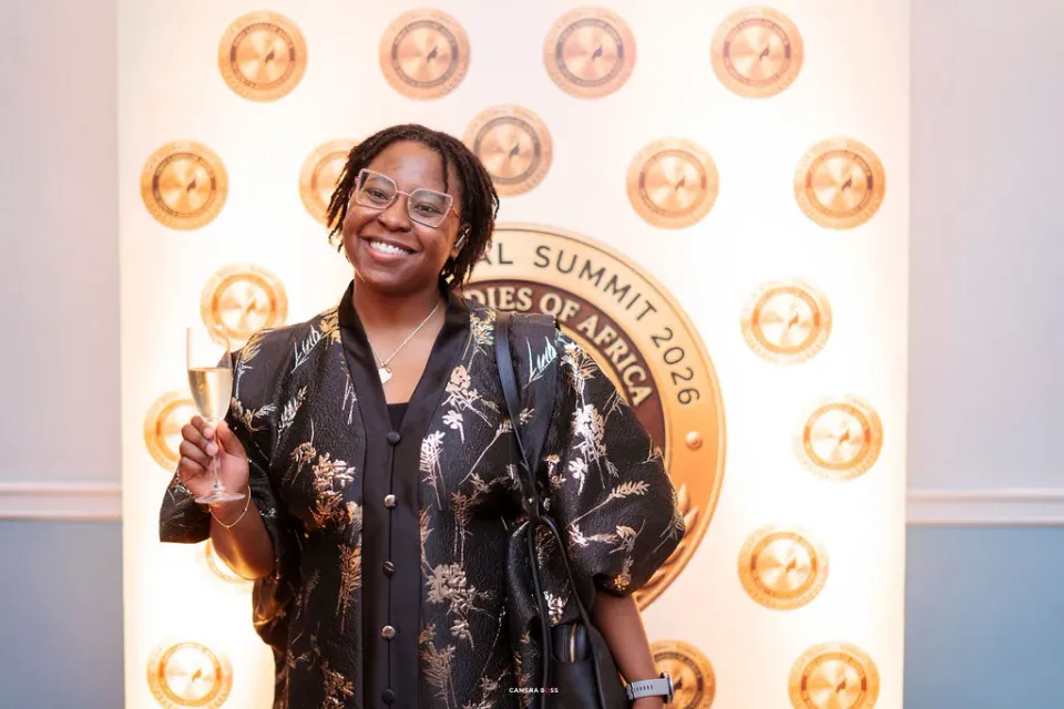 A guest smiling for a portrait at the FLAIR backdrop