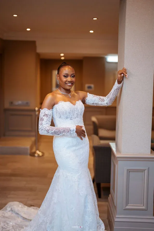 Remi smiling in her dress beside the doorway. CameraBoss portfolio: Remi and Daniel’s Bournemouth civil wedding.