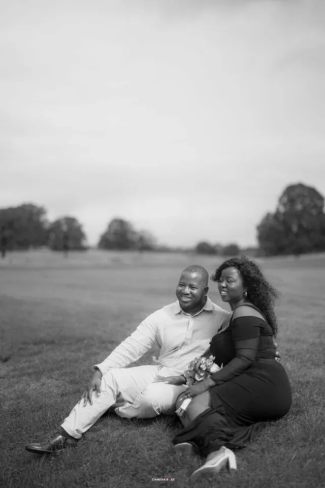 A couple smiling in a black and white seated portrait. CameraBoss portfolio: Oney Prewedding at Boughton House.