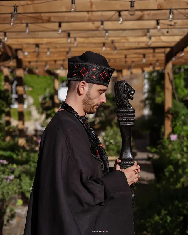 Jonny holding a fan beneath a garden structure. CameraBoss portfolio: Jo and Jonny.