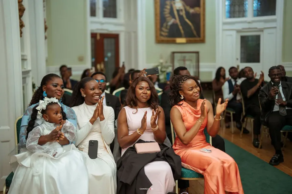 Guests smiling and applauding during Remi and Daniel’s ceremony
