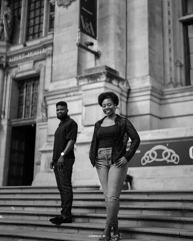 A black and white portrait of a couple on stone steps. CameraBoss portfolio: Tomilayo Prewedding London.