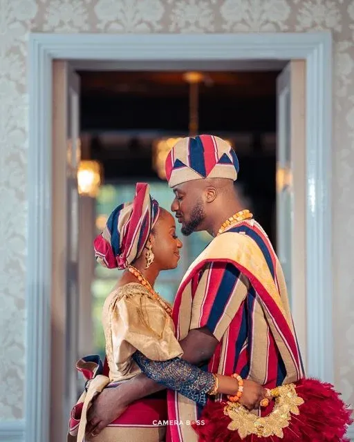 Couple embracing in traditional Yoruba wedding attire